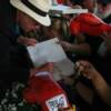 Hall of Famer Bert Randolph Sugar autographs a book