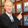 Jimmy Lennon Jr proudly poses by his plaque on the Hall of Fame Wall