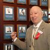 2014 Inductee Graham Houston by his plaque on the Hall of Fame Wall