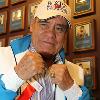 "El Puas" Ruben Olivares in fighting pose by the Hall of Fame Wall.