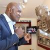 Evander Holyfield goes toe-to-toe with the statue of Canastota's Carmen Basilio.