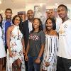 Evander Holyfied and his family pose by his exhibit in the Hall of Fame.