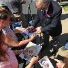 Former welterweight champion and now Hall of Famer Tony DeMarco signs autographs for his fans