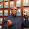 Nigel Benn proudly points to this plaque on the Hall of Fame Wall
